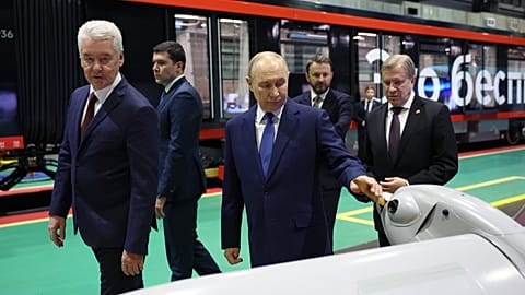 Vladimir Putin, accompanied by his Minister of Industry and Trade Anton Alikhanov, at an exhibition of autonomous vehicles, Moscow, Russia, Jan. 2026