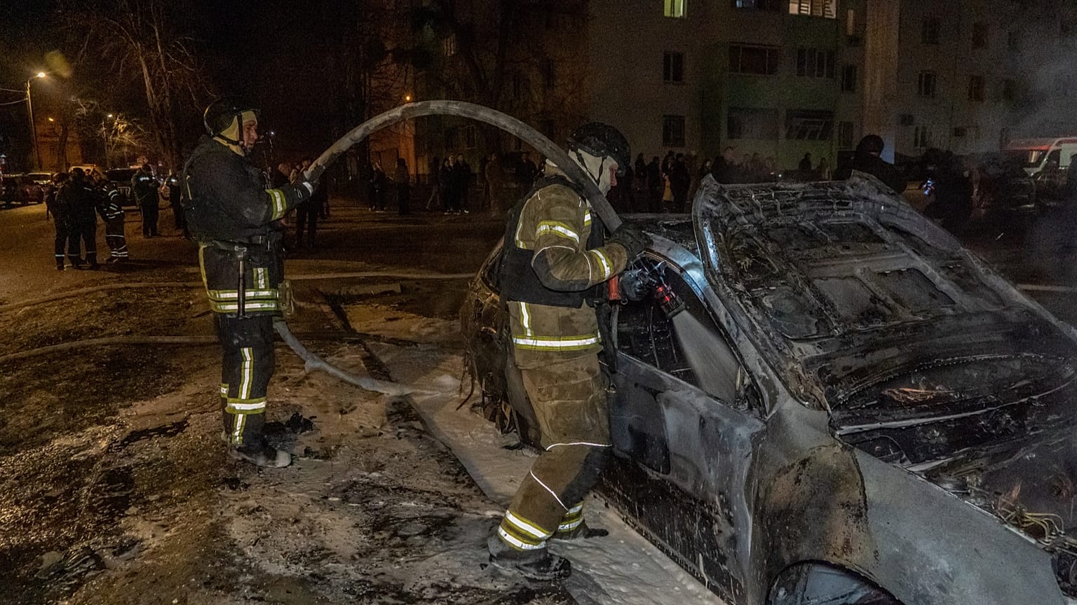Rescuers put out the fire at a residential neighbourhood following Russia's drone attack in Kharkiv, Ukraine, late Monday, 9 March, 2026.
