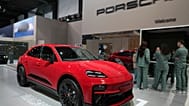 Presenters stand next to the Porsche Macan GTS prior to its European Premiere unveiling, Brussels, Belgium, Jan. 2026