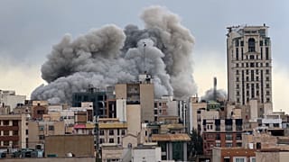 FILE: A plume of smoke rises after a strike in Tehran, 2 March 2026