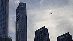 Un avión de Emirates Airlines vuela sobre rascacielos en el centro de Dubái, Emiratos Árabes Unidos, el 7 de marzo de 2026.