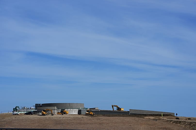 Workers operate heavy duty machines at a construction site for one of the reconstruction memorial parks in the disaster-affected Futaba county, in Namie, northeastern Japan