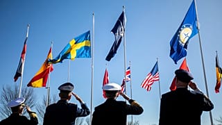FILE: Leadership representing Norfolk-based NATO headquarters salute as the Swedish flag is raised outside of NATO Allied Command Transformation during a ceremony, 11 March 20