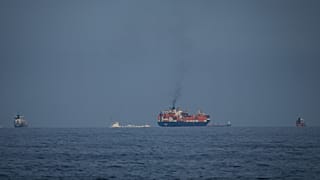 Oil tankers and cargo ships line up in the Strait of Hormuz as seen from Khor Fakkan, United Arab Emirates, Wednesday, March 11, 2026. 