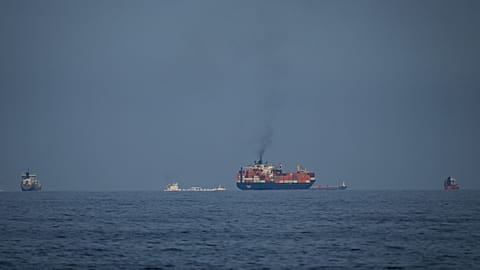 Oil tankers and cargo ships line up in the Strait of Hormuz as seen from Khor Fakkan, United Arab Emirates, Wednesday, March 11, 2026. 