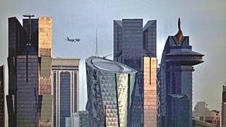 An aircraft flying near skyscrapers of West Bay, approaches the Hamad International Airport in Doha, Qatar, Thursday, Jan. 25, 2024.