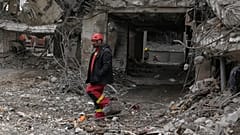 A rescue worker searches the rubble of a residential building in Tehran, Iran, Thursday, March 12, 2026, after it was damaged on Sunday during the U.S. - Israeli air campaign.