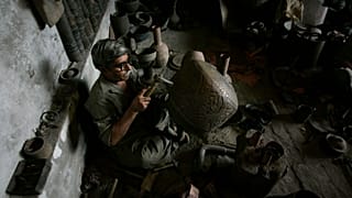 FILE: A Pakistani artist Mohammad Siddique engraves a traditional handicraft in his workshop in Lahore, Pakistan, Tuesday, March 24, 2009.