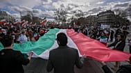 Members of the large Iranian diaspora in France hold an Iranian flag during a demonstration 