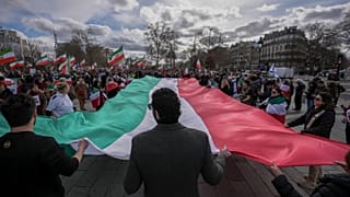 Members of the large Iranian diaspora in France hold an Iranian flag during a demonstration 