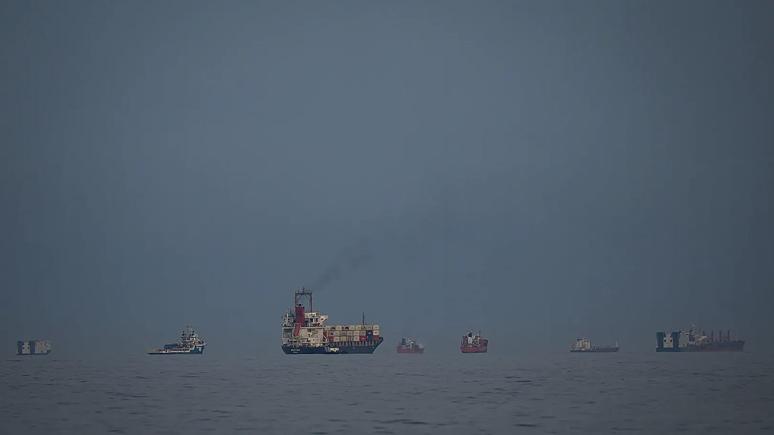 Oil tankers and cargo ships line up in the Strait of Hormuz as seen from Khor Fakkan, 11 March, 2026