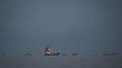 Oil tankers and cargo ships line up in the Strait of Hormuz as seen from Khor Fakkan, 11 March, 2026