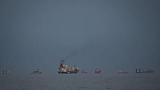 Oil tankers and cargo ships line up in the Strait of Hormuz as seen from Khor Fakkan, 11 March, 2026