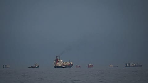 Oil tankers and cargo ships line up in the Strait of Hormuz as seen from Khor Fakkan, 11 March, 2026