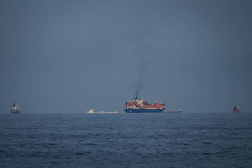 Oil tankers and cargo ships line up in the Strait of Hormuz as seen from Khor Fakkan, 11 March, 2026