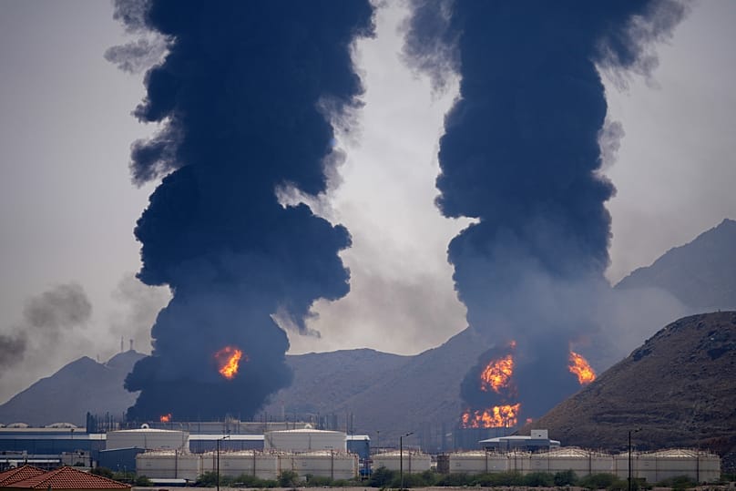 Plumes of smoke and fire rise after debris from an intercepted Iranian drone struck an oil facility, according to authorities, in Fujairah, UAE, March 14, 2026.