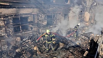 Firefighters put out the fire in a residential neighborhood following a Russian missile and drone attack, in Brovary, close to Kyiv, Ukraine, Saturday, March 14, 2026.