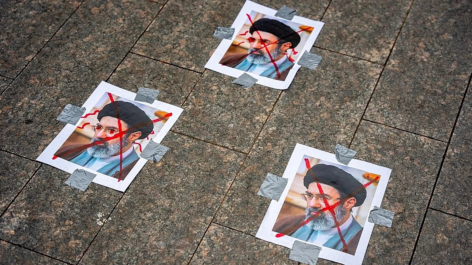 Images of Iranian leader Mojtaba Khamenei lie on the ground at a demonstration in New York, 15 March, 2026