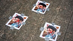 Images of Iranian leader Mojtaba Khamenei lie on the ground at a demonstration in New York, 15 March, 2026