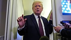 President Donald Trump speaks to reporters aboard Air Force One, Sunday, March 15, 2026