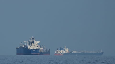 Oil tankers and cargo ships line up in the Strait of Hormuz as seen from Khor Fakkan, United Arab Emirates, Wednesday, March 11, 2026. 