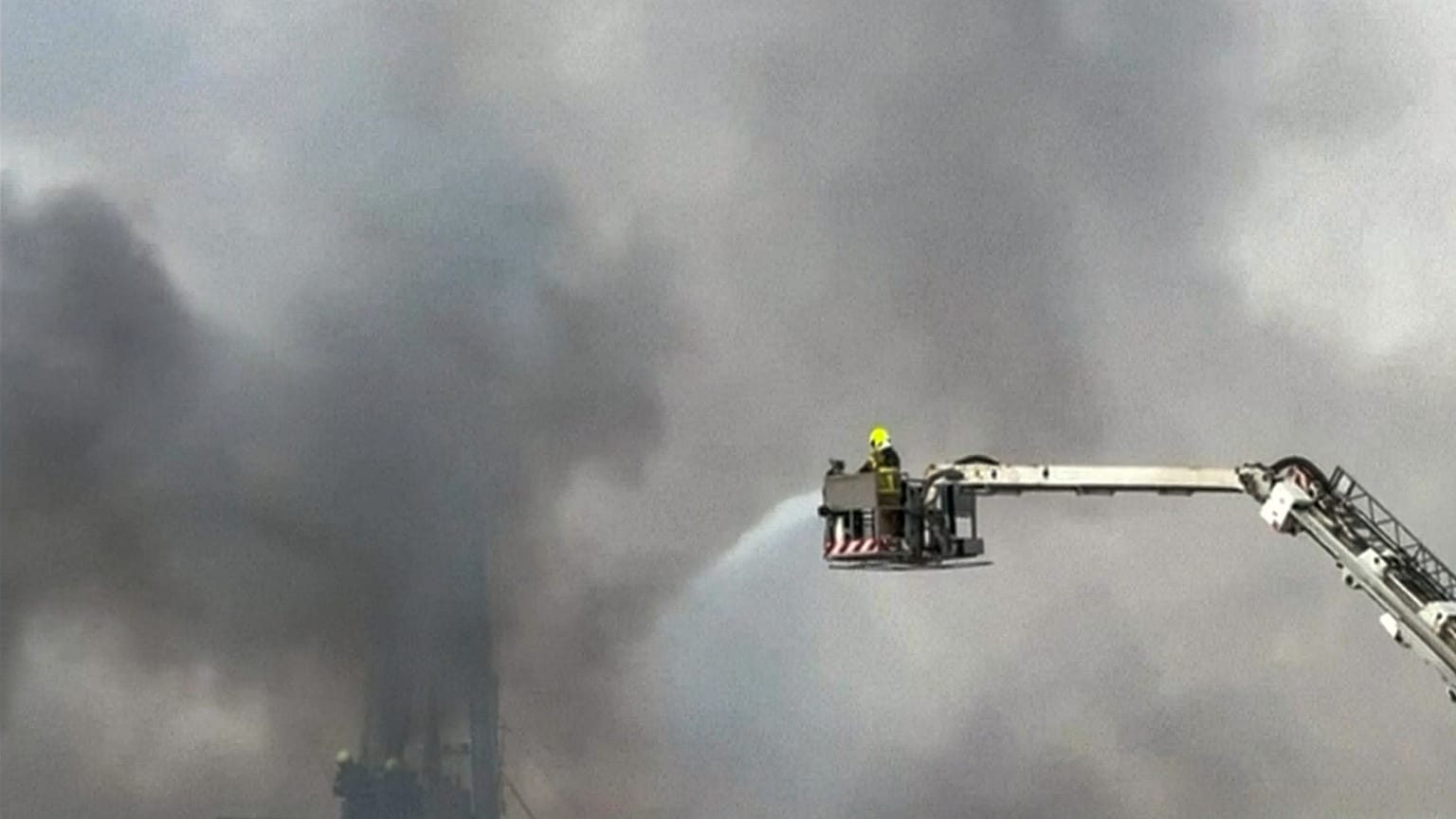 FILE: This image taken from a video shows firefighters trying to extinguish a fire which, according to the authorities was caused by a successful interception in Dubai