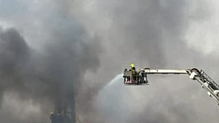 FILE: This image taken from a video shows firefighters trying to extinguish a fire which, according to the authorities was caused by a successful interception in Dubai