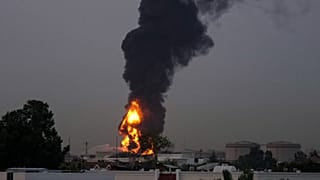 Fire and plumes of smoke rises after drone struck a fuel tank forcing the temporary suspension of flights, near Dubai International Airport, UAE, Monday, March 16, 2026