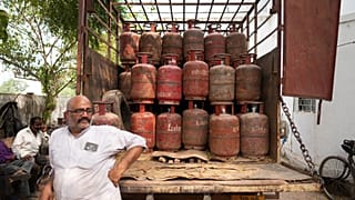 An employee at a depot waits to distribute household cylinders of liquified natural gas to consumers, in Lucknow, India, Wednesday, March 11, 2026. 