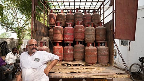 An employee at a depot waits to distribute household cylinders of liquified natural gas to consumers, in Lucknow, India, Wednesday, March 11, 2026. 