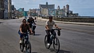 People ride their bicycles along the Malecón during a blackout in Havana, Cuba, 16 March 2026