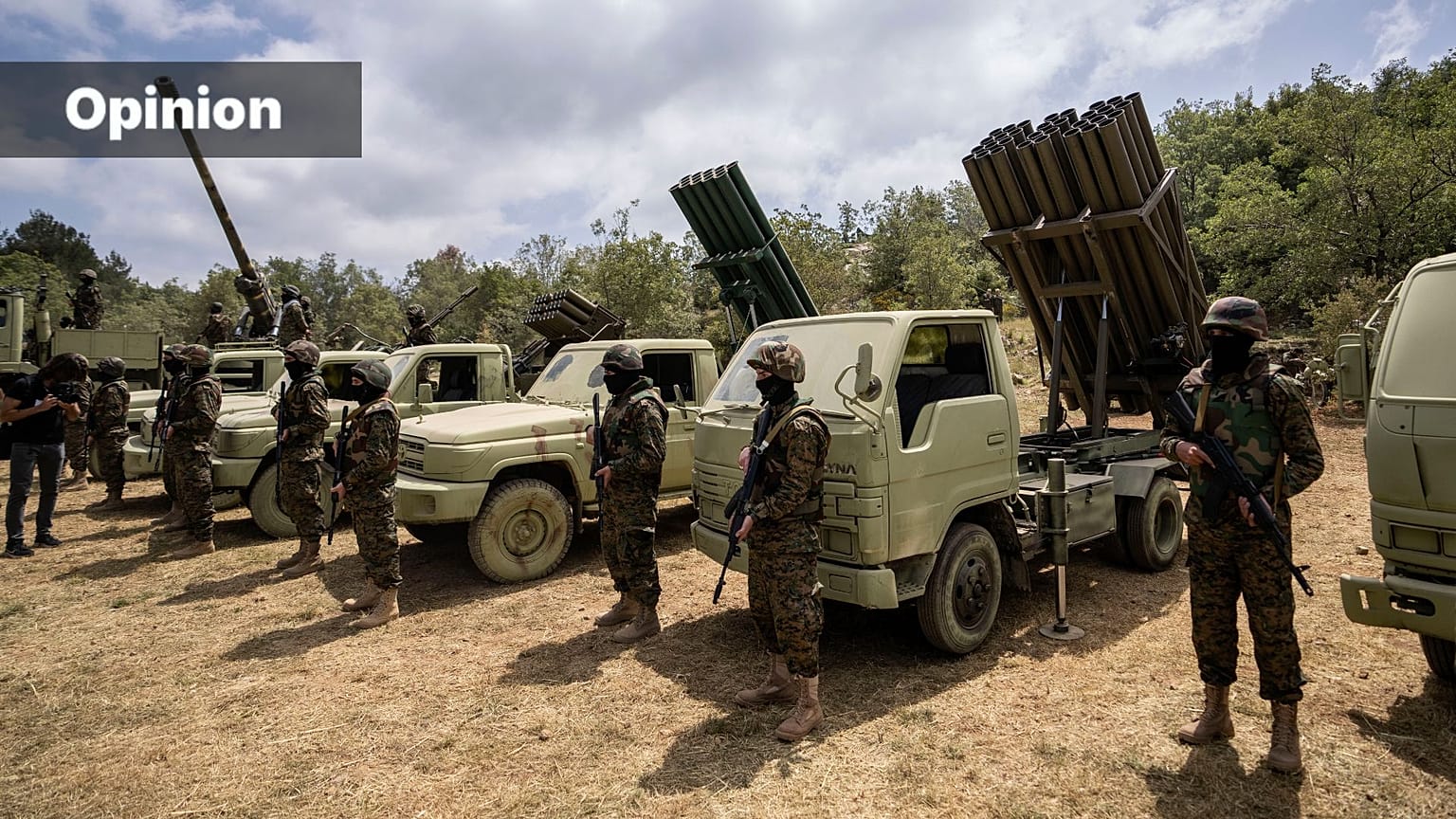 FILE: Fighters from the Lebanese militant group Hezbollah carry out a training exercise as they stand in front of launcher rockets trucks, southern Lebanon, May 21, 2023