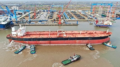 Tugboats guide a very large crude carrier (VLCC) on the Yangtze River in Qidong, eastern China. (AP Photo)