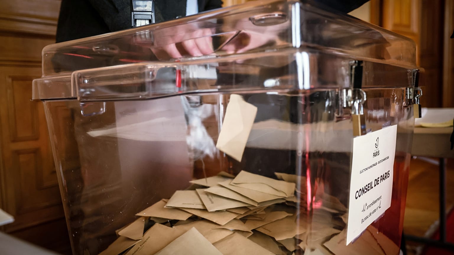 Une femme vote lors du premier tour des élections municipales françaises à Paris, le dimanche 15 mars 2026.