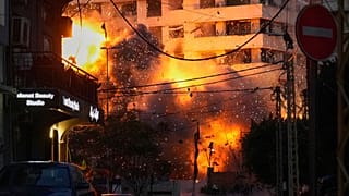 An explosion erupts from a building following an Israeli strike in central Beirut, Lebanon, Wednesday, March 18, 2026