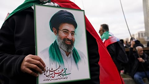 FILE - A demonstrator holds a portrait of the Ayatollah Mojtaba Khamenei during the Al Quds day in London, England, Sunday, March 15, 2026. (AP Photo/Alberto Pezzali)