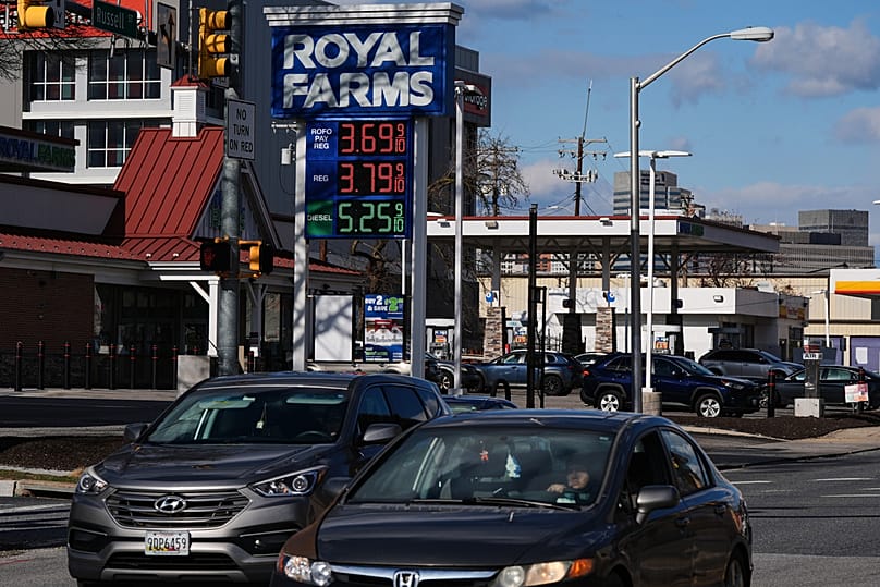 Fuel prices are displayed on a sign at a gas station as cars drive by, in Baltimore, United States, Tuesday, March 17, 2026