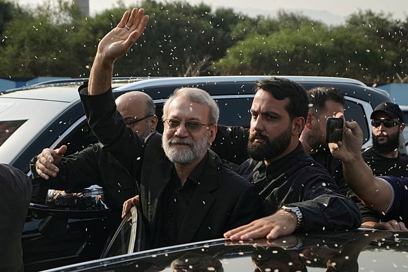 FILE - Ali Larijani, head of Iran's National Security Council, gestures as Hezbollah supporters throw rice to welcome him in Beirut, Lebanon, Wednesday, Aug. 13, 2025