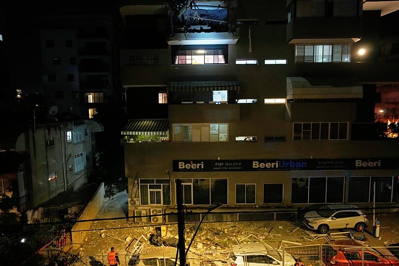 Israeli security forces inspect the site of an Iranian missile strike that killed two people in Ramat Gan, Israel, Wednesday, March 18, 2026