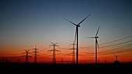 Wind turbines stand in a field near Pulheim, North Rhine-Westphalia, Germany, after sunset on Tuesday, March 3, 2026.