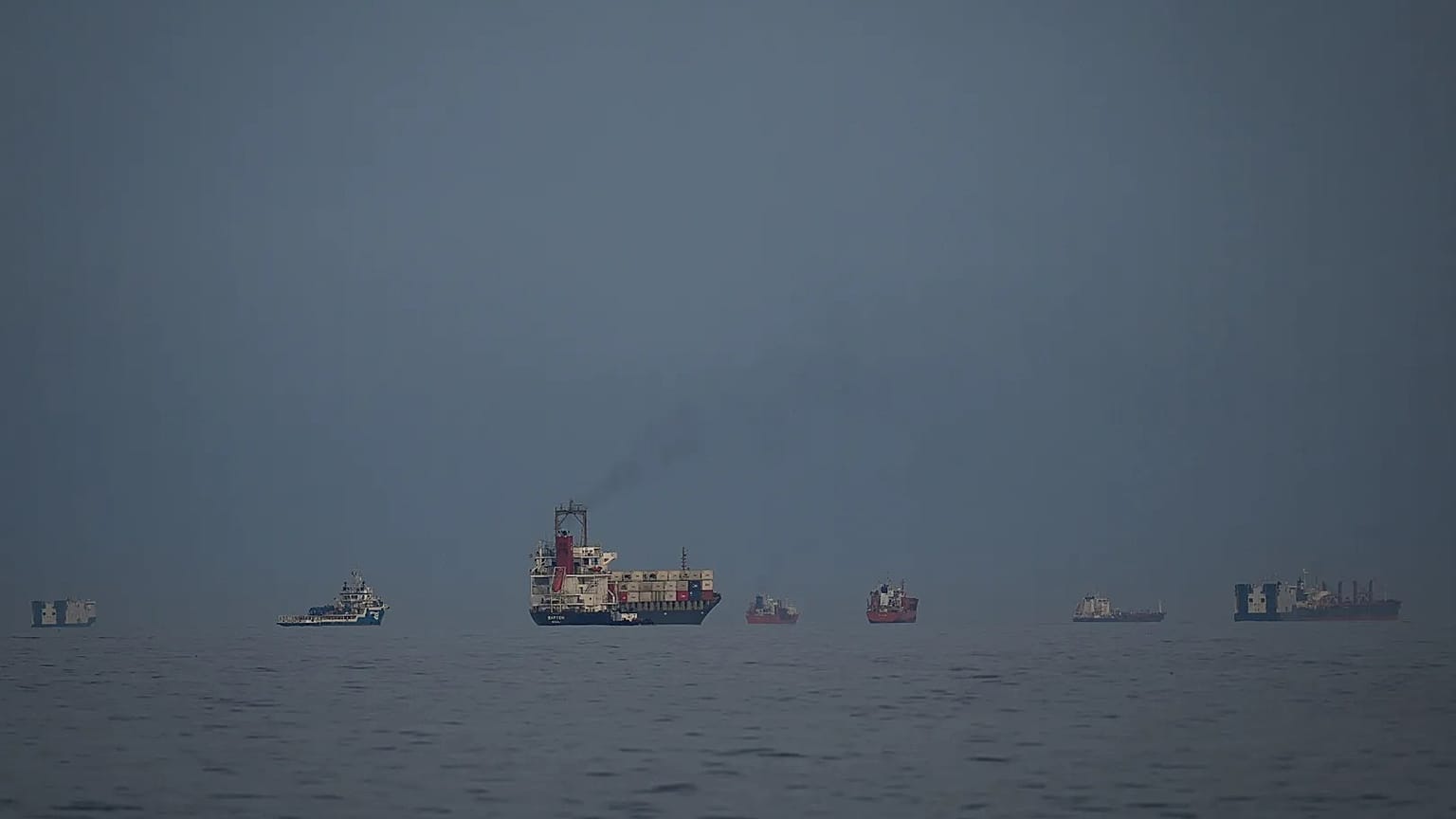 Oil tankers and cargo ships line up in the Strait of Hormuz as seen from Khor Fakkan, 11 March, 2026