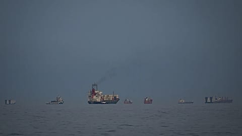 Oil tankers and cargo ships line up in the Strait of Hormuz as seen from Khor Fakkan, 11 March, 2026