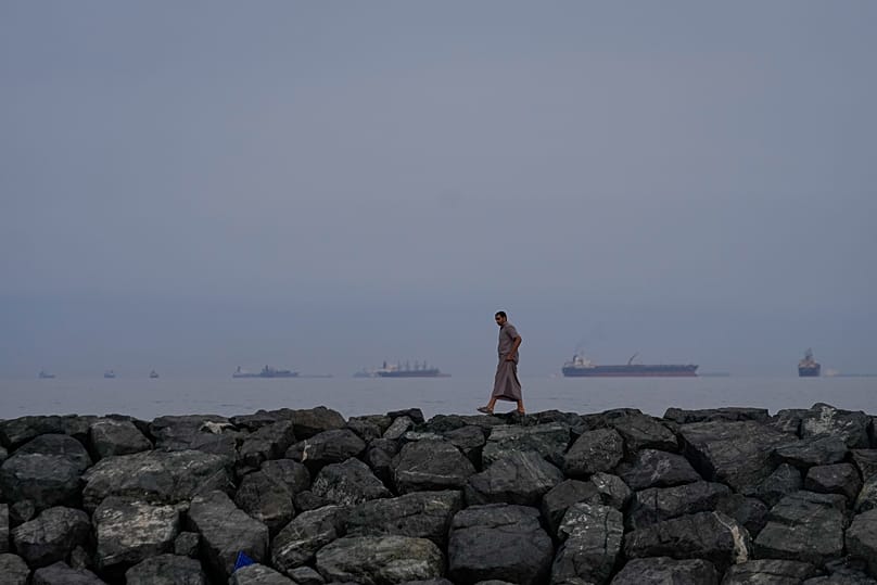 Oil tankers and cargo ships line up in the Strait of Hormuz as seen from Khor Fakkan, 11 March, 2026