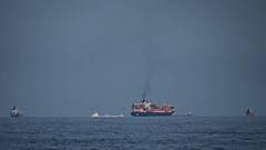 Oil tankers and cargo ships line up in the Strait of Hormuz as seen from Khor Fakkan, 11 March, 2026
