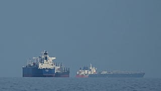 Oil tankers and cargo ships line up in the Strait of Hormuz as seen from Khor Fakkan, 11 March, 2026