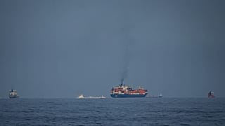 Oil tankers and cargo ships line up in the Strait of Hormuz as seen from Khor Fakkan, 11 March, 2026