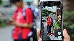  Students play Pokemon Go in the street as its released in Tokyo (AP Phot/Koji Sasahara)