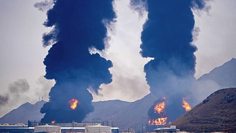 Plumes of smoke and fire rise after debris from an intercepted Iranian drone struck an oil facility, according to authorities, in Fujairah, United Arab Emirates, Saturday,