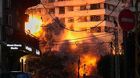 An explosion erupts from a building following an Israeli strike in central Beirut, Lebanon, 18 March 2026
