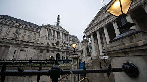 FILE -A man walks in front of the Bank of England, at the financial district in London. 5 Feb. 2026